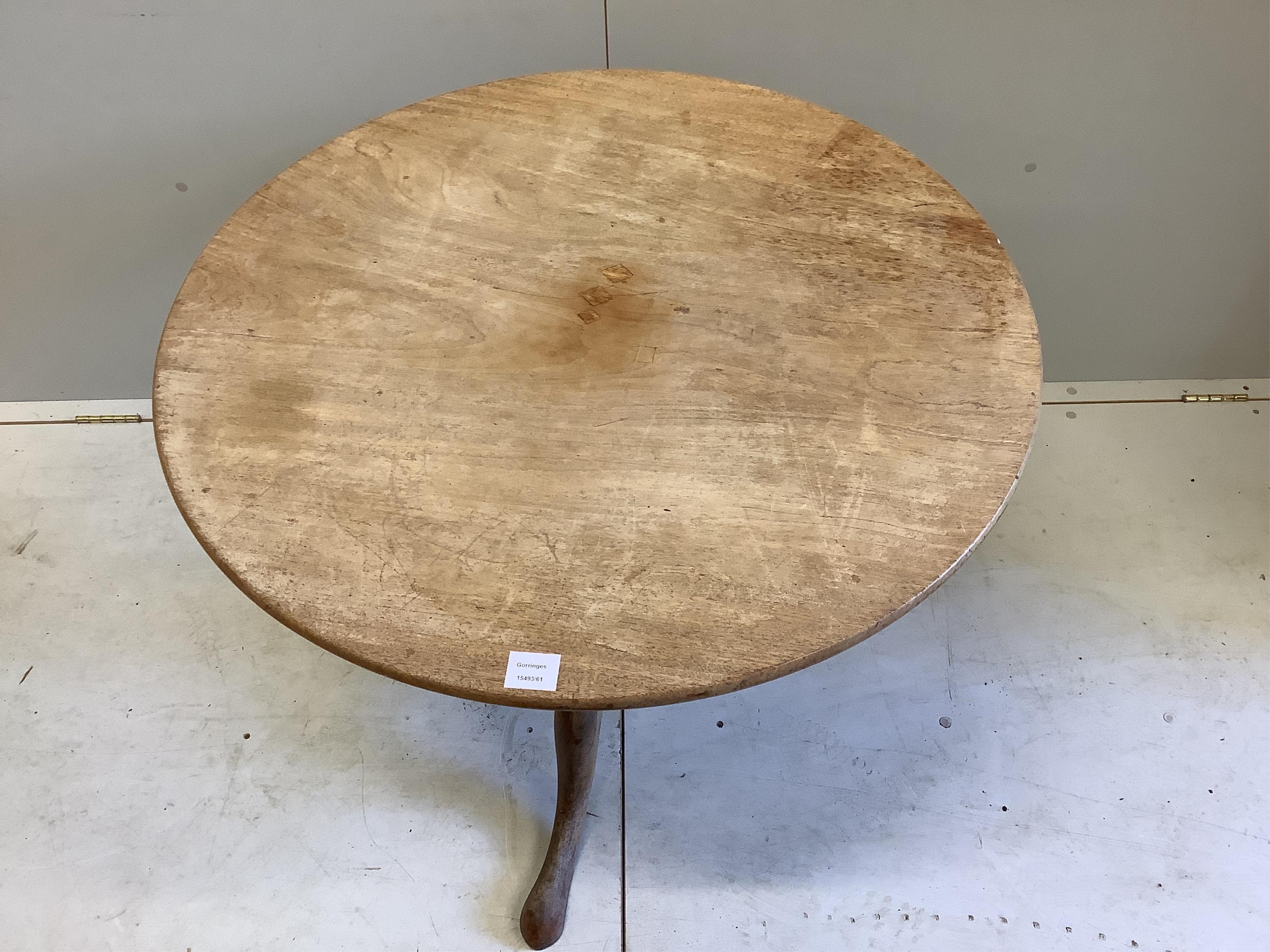 A George III circular faded mahogany tilt top tripod tea table, diameter 85cm, height 70cm. Condition - poor